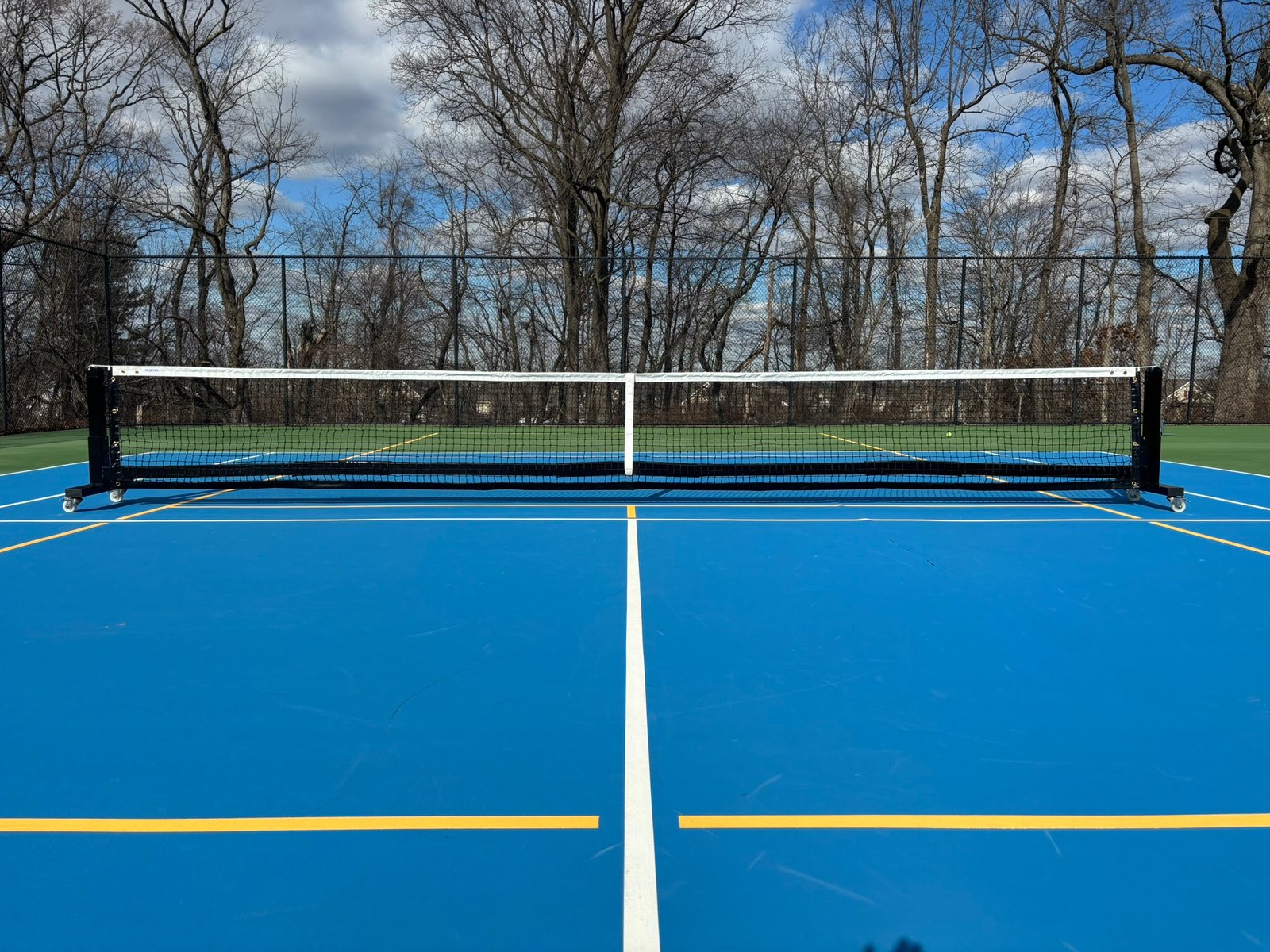 Pro Heavy Duty Portable Pickleball Net | Optional Wheels 2 Front view of 22 ft portable pickleball net on wheels showing straight top line without a center support rod.