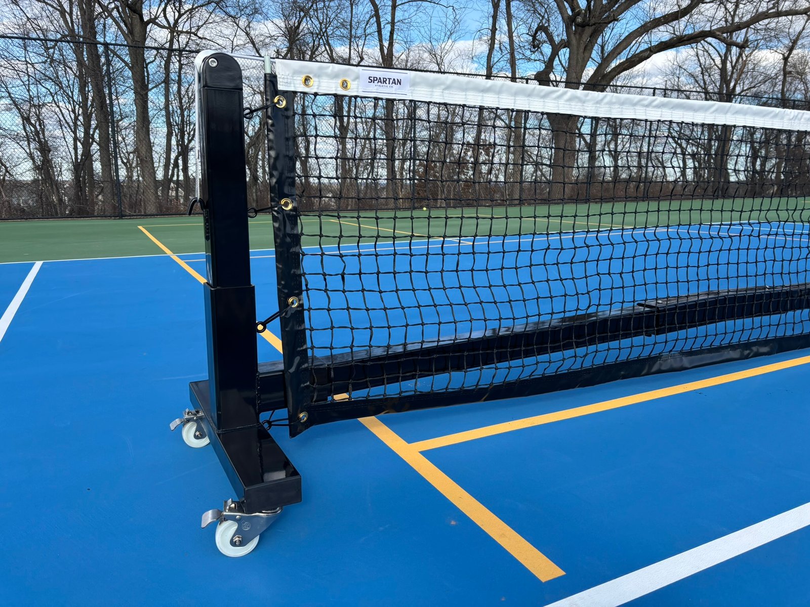 Pro Heavy Duty Portable Pickleball Net | Optional Wheels 8 Outdoor pickleball net post on wheels with stainless steel crank handle and sturdy base.