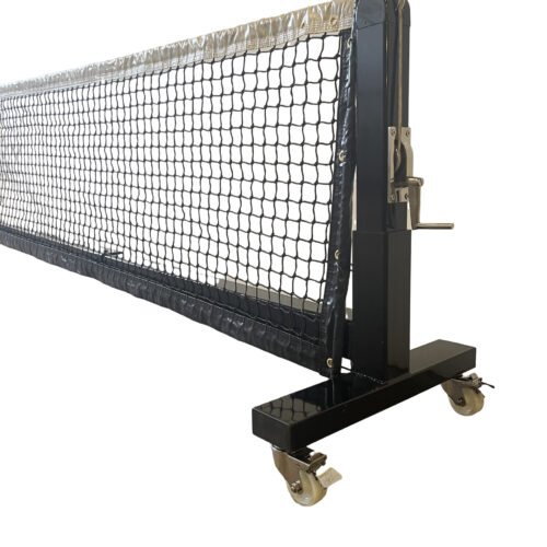 Wide shot of pro portable pickleball net on wheels positioned on a blue and green court.